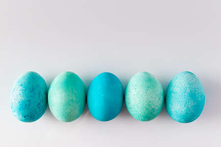 Beautiful blue easter eggs on a light background. Festive composition for design. Place for your text.の写真素材