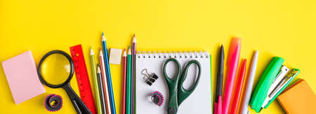Back to school concept. Flat lay of office supplies on a yellow background. Place for text. Banner...