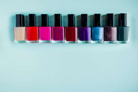 Palette of bright nail polishes on a blue background.の写真素材