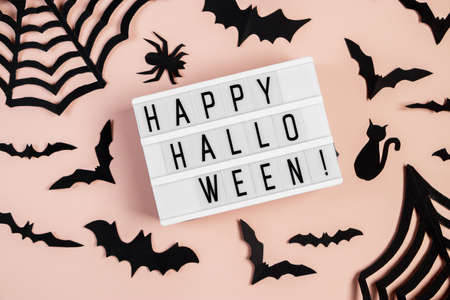 Halloween concept. Bats and spiders on a pink background. Festive decorations.の写真素材