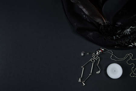 Halloween symbols on black background. Skeleton, witch hat and candle.の写真素材