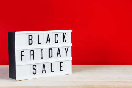 Black Friday concept. Sign on a red background. Place for text.の写真素材