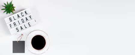 Black Friday concept. Cup of coffee and lightbox on white background. Sale and discounts. Place for textの写真素材