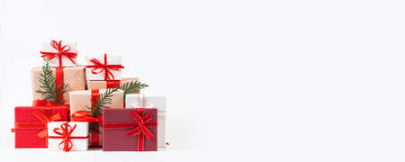 Stack of beautiful gift boxes on a white background. Festive New Year concept.の写真素材