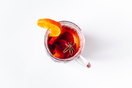 Glass cup with mulled wine on a white background. Winter warming drink.の写真素材