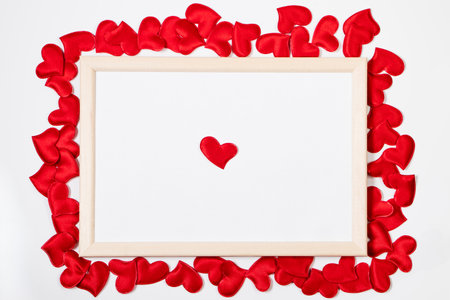 Valentine's day greeting card. Frame from red hearts on white background. Layout with place for text.の写真素材
