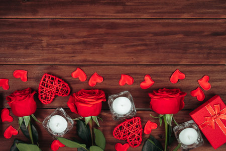 Red roses and hearts on dark wooden background. Valentines day postcard concept.の写真素材
