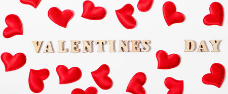 Red hearts and inscription Valentine's Day on white background. Lovers' holiday concept, greeting card.の写真素材