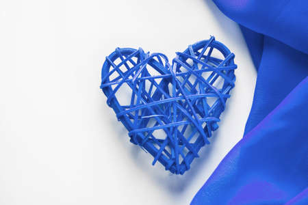 One blue heart and  silk ribbon frame on  white background. Place for text, design for valentines...