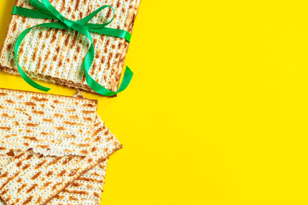 Traditional Jewish matzo on yellow background. Happy Passover. Pesach religious holiday celebration concept.の写真素材