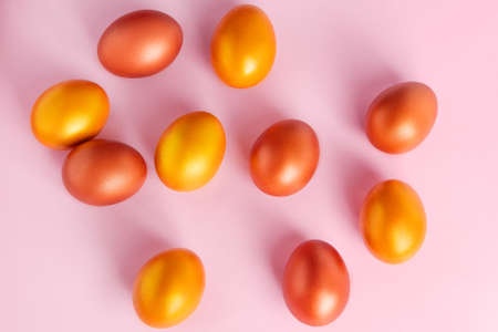 Shining golden eggs on a pink background. Happy Easter. Place for text.の写真素材