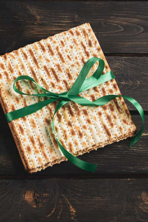 Matzah background. Happy Passover. Traditional Jewish regilious holiday Pesach. Matzo bread on dark...