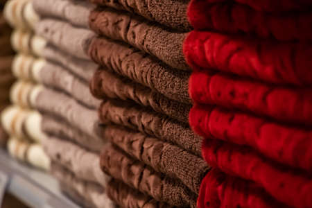 A stack of multi-colored bath towels close-up. Spa accessories for health care.の写真素材