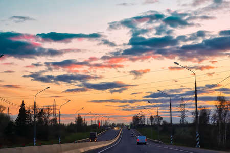 Highway at sunset. View of asphalt road from the car window.の写真素材