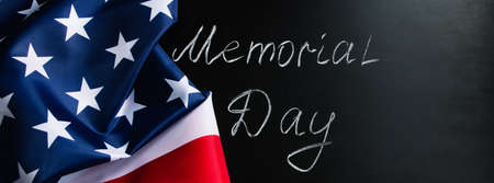 Memorial day concept. Handwritten lettering on black chalkboard and American flag. Remember and...