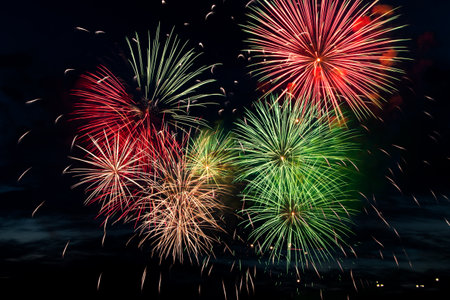 Bright colored fireworks on a black background. Celebration and holidays concept. New Year, Independence Day, July 4 Festival. Bright explosions of lights in the sky. Place for your text.の写真素材