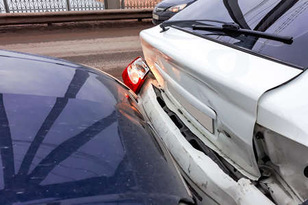 Accident on the road. Damaged cars after a collision. Fragment of a broken bumper.