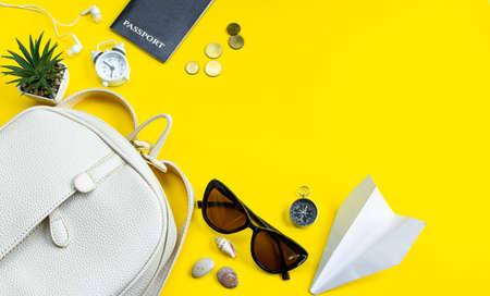 Summer travel concept. Traveler's accessories. Passport, money, sunglasses on a yellow background. Place for your text, flatlay.の写真素材