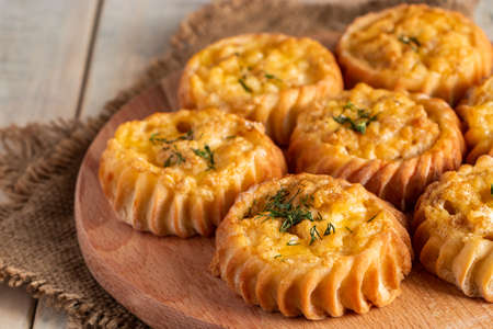 Fresh muffins with vegetables and cheese on a wooden board. Delicious homemade cakes for healthy diet. Recipe for autumn seasonal dish.の写真素材
