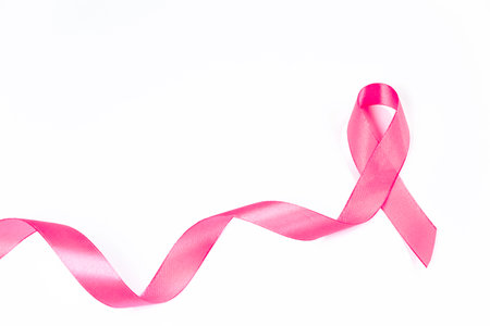 Pink ribbon on white background. Breast Cancer Awareness Month. Womens health care concept. Symbol of hope and support. Copy space.の写真素材