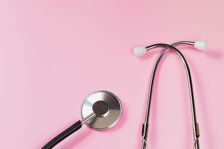 Stethoscope on pink background. Health care concept. Medical instrument for diagnosing diseases. Copy space.の写真素材