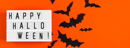 Happy Halloween. Paper bats on an orange background. Banner formatの写真素材