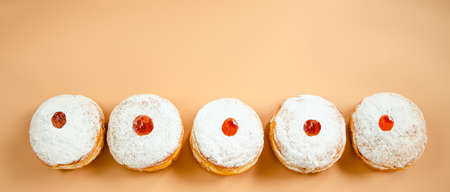 Happy Hanukkah. Traditional Jewish dessert Sufganiyot. Celebrating Judaism holiday. Donuts with jam...