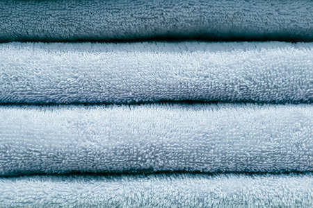 Stack of bath towels. Home textiles for spa treatments. Soft fluffy fabric texture.の写真素材
