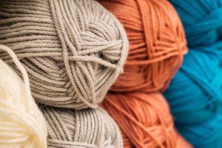 Multi-colored balls of yarn for knitting. Woolen threads for needlework.