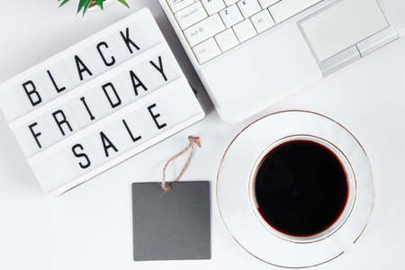 Black Friday concept. Laptop and coffee cup on white background. Online sale, discounts.