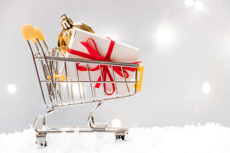 New Year shopping. Mini cart with gift boxes on a white background.の写真素材