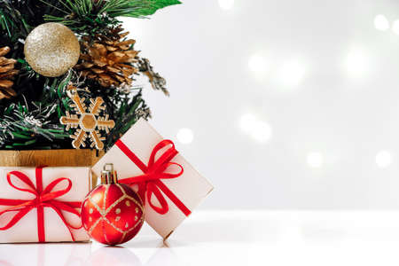 Artificial Christmas tree with gifts on a white background. New Year concept, holiday card.の写真素材