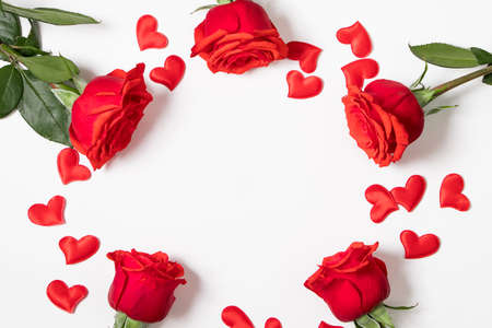 Frame from red hearts and roses on white background. Valentine's day greeting card. Layout with...