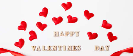 Red hearts and inscription Valentine's Day on white background. Lovers' holiday concept, greeting card.の写真素材