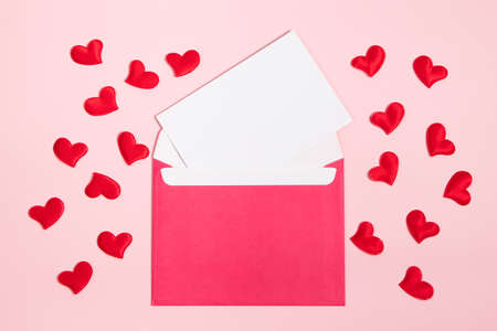Envelope with greeting card for valentine's day. Romantic holiday concept. Hearts on pink background.の写真素材