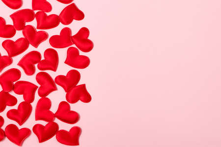 Red hearts on pink background. Minimalistic concept for valentine's day. Place for your text.