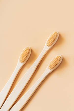 Eco-friendly wooden toothbrushes on trendy beige background. Dental care concept. Happy dentist day. Greeting card.の写真素材