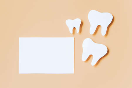 Eco-friendly wooden toothbrushes on trendy beige background. Dental care concept. Happy dentist day. Greeting card.の写真素材