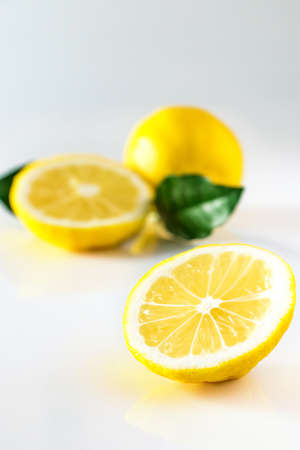 Ripe yellow lemon on white background. Antioxidant for healthy diet. Citrus fruit high in vitamin C.の写真素材