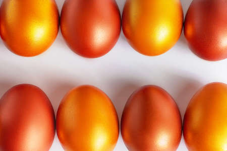 Background from golden Easter eggs on a white background. Place for text.の写真素材