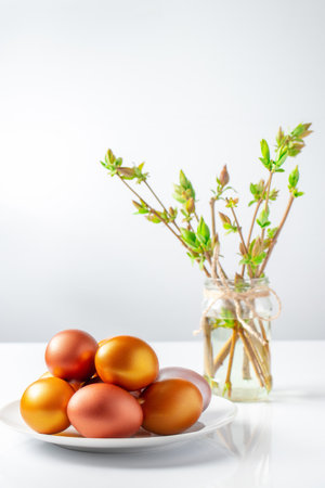 Gold and bronze Easter eggs on white background. Happy Christian holiday symbol.の写真素材