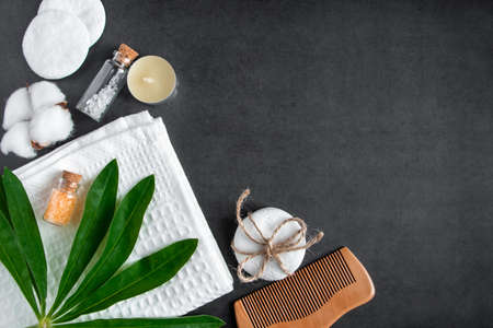 Cosmetics and spa accessories on concrete background. Face and body care concept. Towel, hairbrush,...