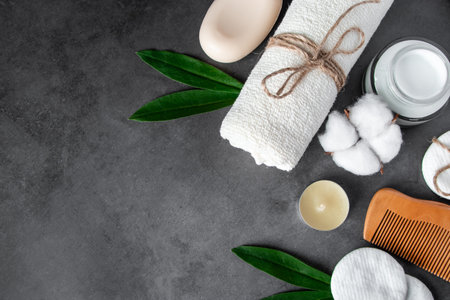 Natural body care cosmetics on concrete background. Spa accessories, towel, hairbrush, essential oil. Flat lay composition. Eco-friendly products, zero waste. Copy space.の写真素材