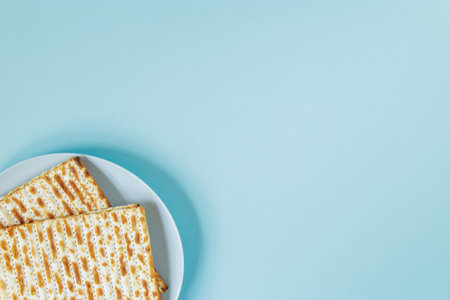 Matzo on blue background. Happy Passover concept. Traditional Jewish food for Pesach. Place for your text.の写真素材