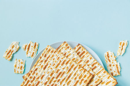 Matzo on blue background. Happy Passover concept. Traditional Jewish food for Pesach. Place for your text.の写真素材