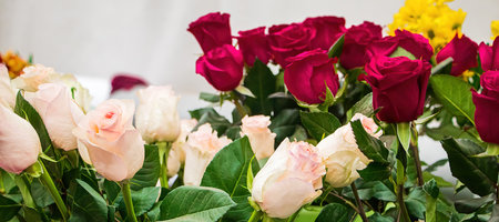 Bouquets of roses in flower shop. Selling fresh flowers for Valentines Day. Multi-colored flowers close-up.の写真素材