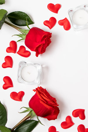 Bouquet of red roses, hearts and candles on white background. Valentine's day February 14. Place for your text.の写真素材