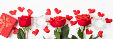 Bouquet of red roses, hearts and candles on white background. Valentine's day February 14. Place for your text.の写真素材