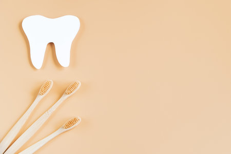 International Dentist Day. Happy dentists day. Eco-friendly wooden toothbrushes on trendy beige background. Dental care concept. Greeting card.の写真素材