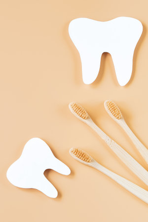 Eco-friendly wooden toothbrushes on trendy beige background. Dental care concept. Happy dentist day. Greeting card.の写真素材